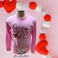 https://www.stinesassystitches.com/products/valentines-shirt-love-conquers-all